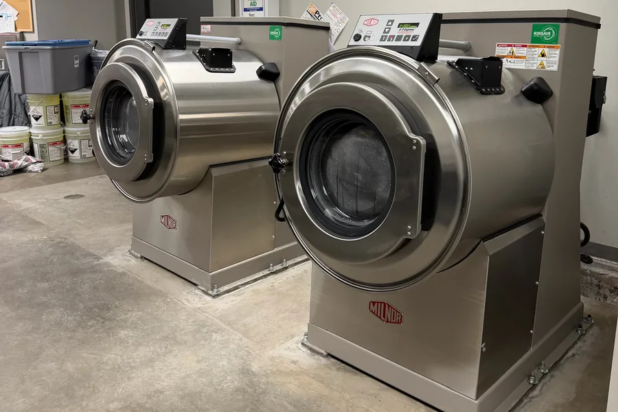 Industrial Milnor washer-extractors installed by Arrow Machinery in a commercial laundry plant