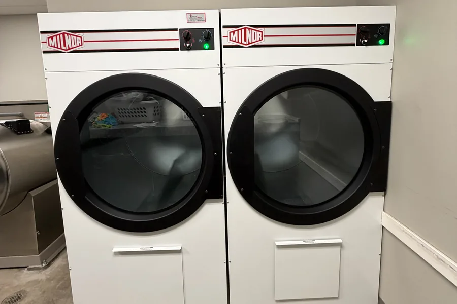 Two Milnor commercial dryers installed by Arrow Machinery in an Oklahoma City hotel laundry room