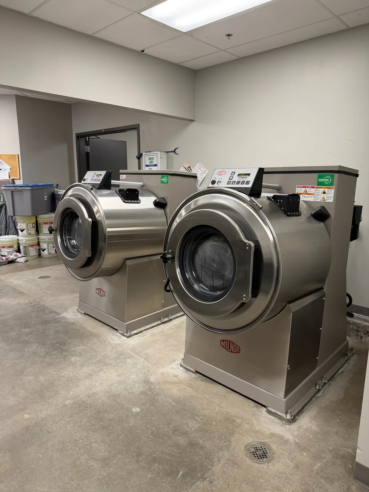 Two Milnor washer-extractors installed by Arrow Machinery in a commercial laundry room
